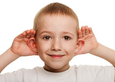 male child with hands behind his ears